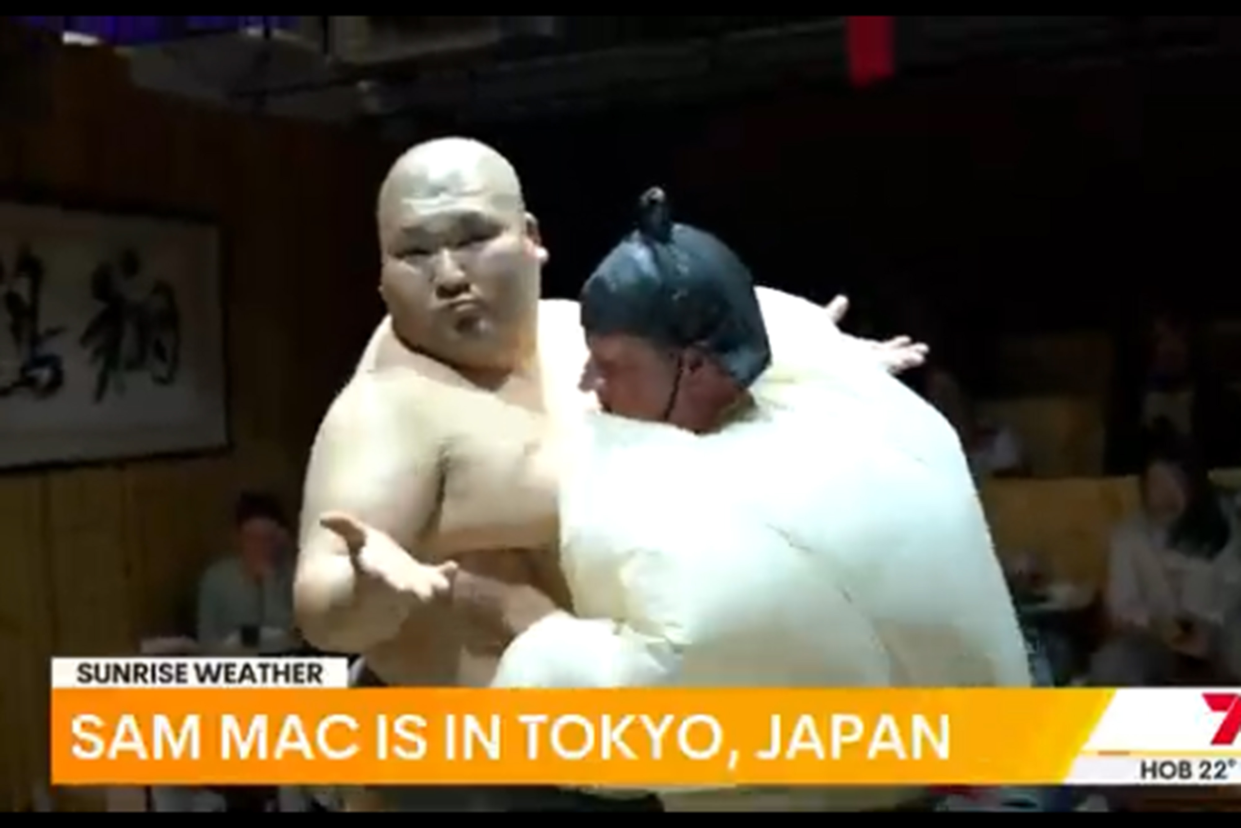 Sam Mac (right) trying his hardest to push a sumo wrestler in Tokyo, Japan.