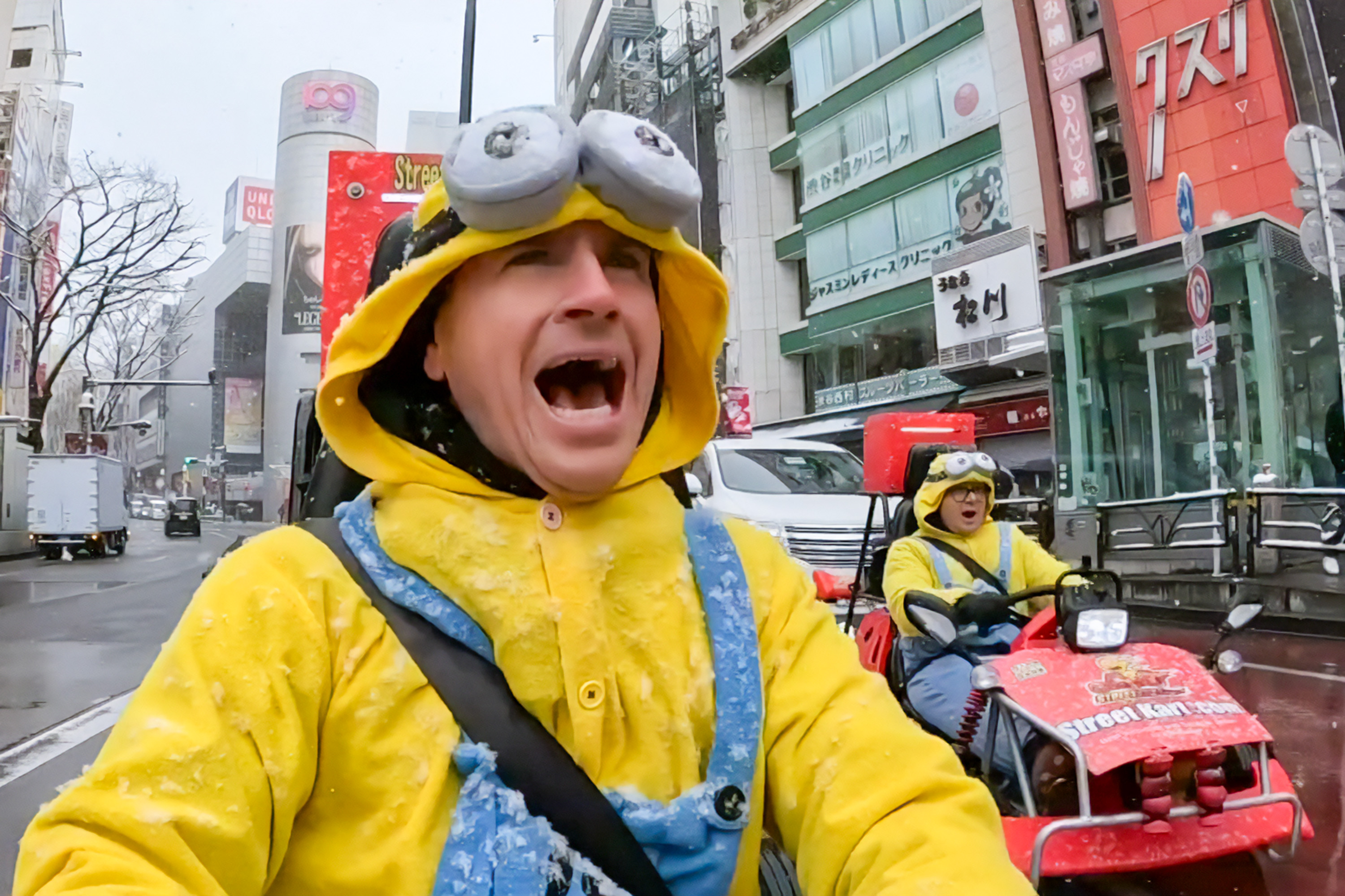 Sunrise's weather man Sam Mac (left) and his producer karting through Tokyo on a snowy day.