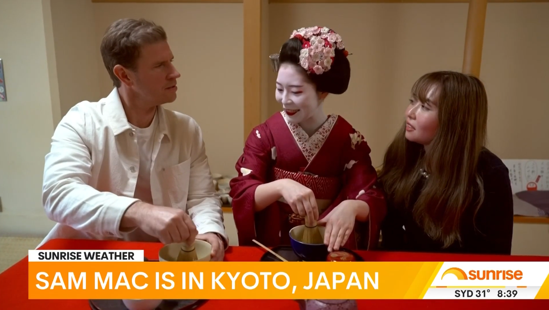 From left, Sam Mac during Wednesday's live cross with a maiko apprentice and translator Sayaka.